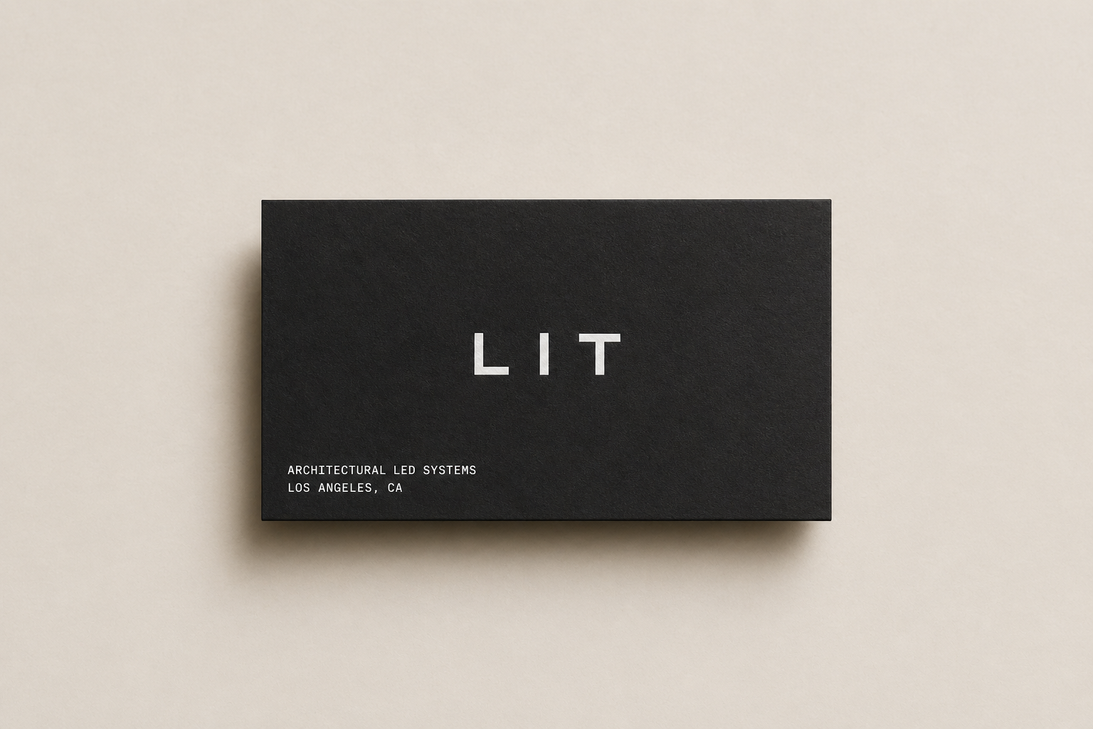 Matte black Lit Group business card with LIT compact wordmark and architectural LED systems descriptor.